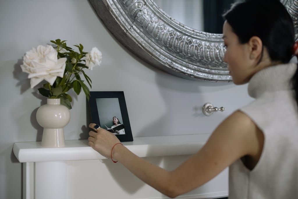 Woman Looking at the Photo in the Picture Frame